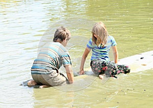 Girl and boy playing on surf