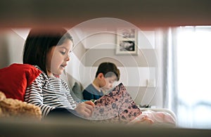 Girl and boy reading a book