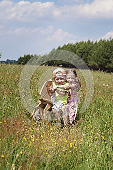 Girl with a boy riding a horse