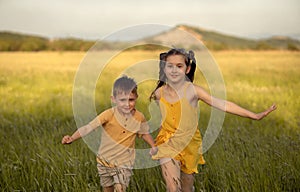 the girl and boy running across the field
