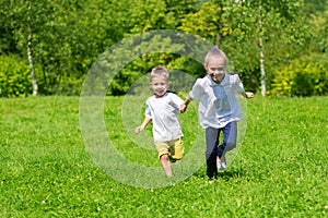 Girl and boy running on the grass