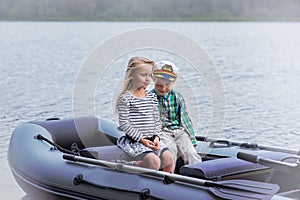 Girl and boy`s best friend sailing boat on the lake a summer day