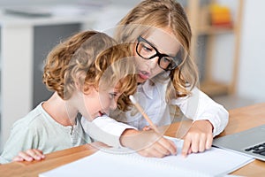 Girl and boy sitting at the table