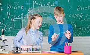 Girl and boy smart students conduct school experiment. School education. Chemical analysis. Kids busy study chemistry