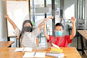Girl boy student wearing face mask stretching after studying hard feeling tired bored sleepy. children education
