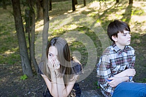 Girl and boy Teens sit back to each other. Resentment, bad relationship