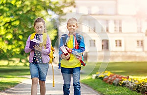Girl and boy walking to the educational building together.