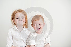 A girl and a boy in white clothes