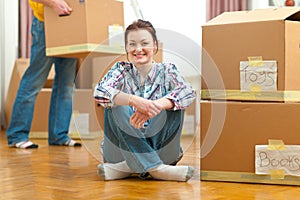 Girl and boyfriend carrying boxes to new house