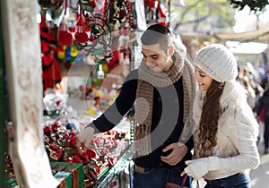 Girl with boyfriend choosing tradition catalan Christmas souven