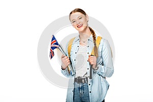 Girl with braid and backpack holding flag of united kingdom and copybooks isolated on white