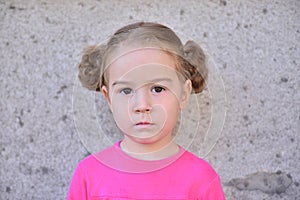 Girl with braids against the wall