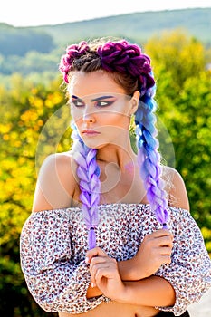 Girl braids. Bright makeup, rose-colored, braids, pigtails hairstyle. Girl with colorful kanekalon braided in her hair