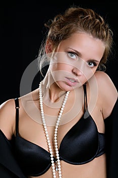 The girl in a brassiere and beads photo