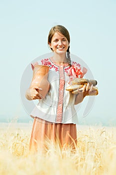 Girl with bread at rye field