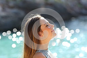 Girl breathing fresh air on a tropical beach on holidays