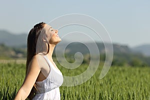 Girl breathing fresh air with white dress photo