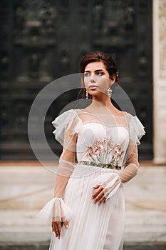 Girl-bride wedding dress with a beautiful floral pattern in Florence, stylish bride in a wedding dress stands in the Old city of