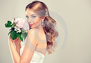 Girl bride in wedding dress with elegant hairstyle.