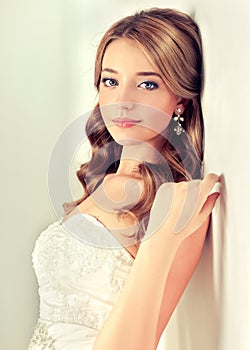 Girl bride in wedding dress with elegant hairstyle.