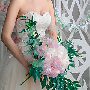 Girl-bride in a wedding dress with an object in her hands