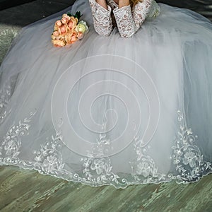 Girl-bride in a wedding dress with an object in her hands