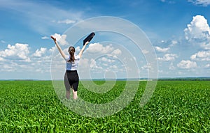 Girl with a briefcase walking on grass