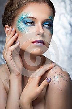 Girl with bright make-up and sparkles