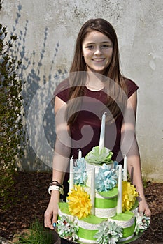 Girl brings birthday cake made of toilet paper