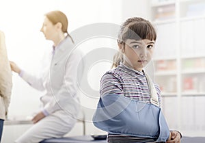 Girl with broken arm and arm brace in the doctor`s office