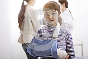 Girl with broken arm and arm brace in the doctor`s office