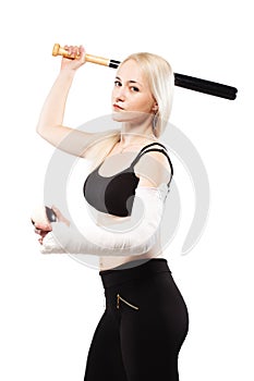 Girl with a broken arm holding baseball bat and ball