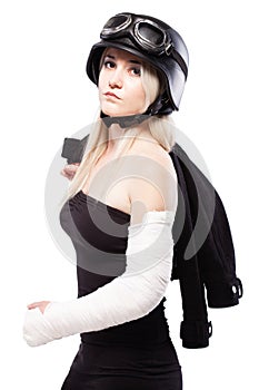 Girl with a broken arm in plaster, wearing motorcycle helmet