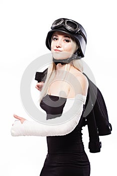 Girl with a broken arm in plaster, wearing motorcycle helmet