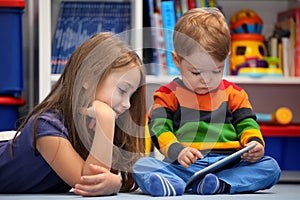 Girl and brother fun using a digital tablet computer