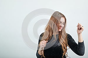 Girl brown haired in black dress over  white background shows emotions