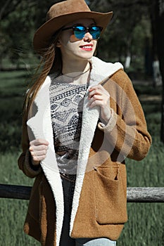 Girl in brown hat and sunglasses