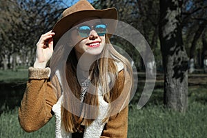 Girl in brown hat and sunglasses