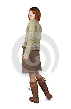 Girl in brown skirt standing and looking back