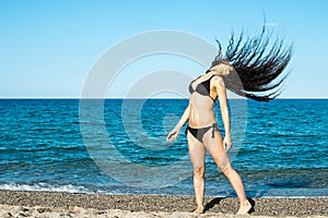 Girl brunette on the beach try a dancer
