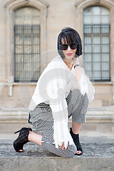 Girl with brunette hair, red lips in sunglasses