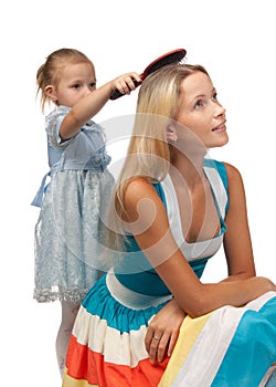 Girl brushes hair of mum