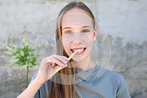 A girl brushes her teeth siwak stick. Miswak sticks