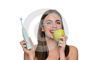 Girl brushing her teeth. White teeth. Dental health care clinic. Electric toothbrush. Woman toothy smile isolated on