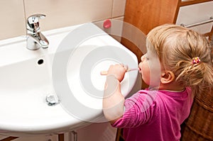 Girl brushing teeth photo