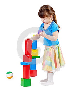 Girl build a tower of toy bricks