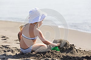 Girl building a sand castle on the beach