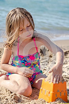Girl building sand castles
