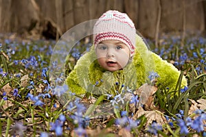 A girl with bunch of bluebells in spring forest