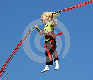 Girl on bungee trampoline